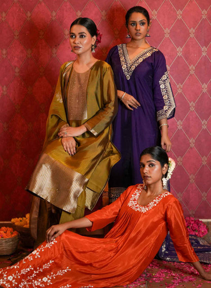 Radiate vibrant elegance with this striking orange ethnic set